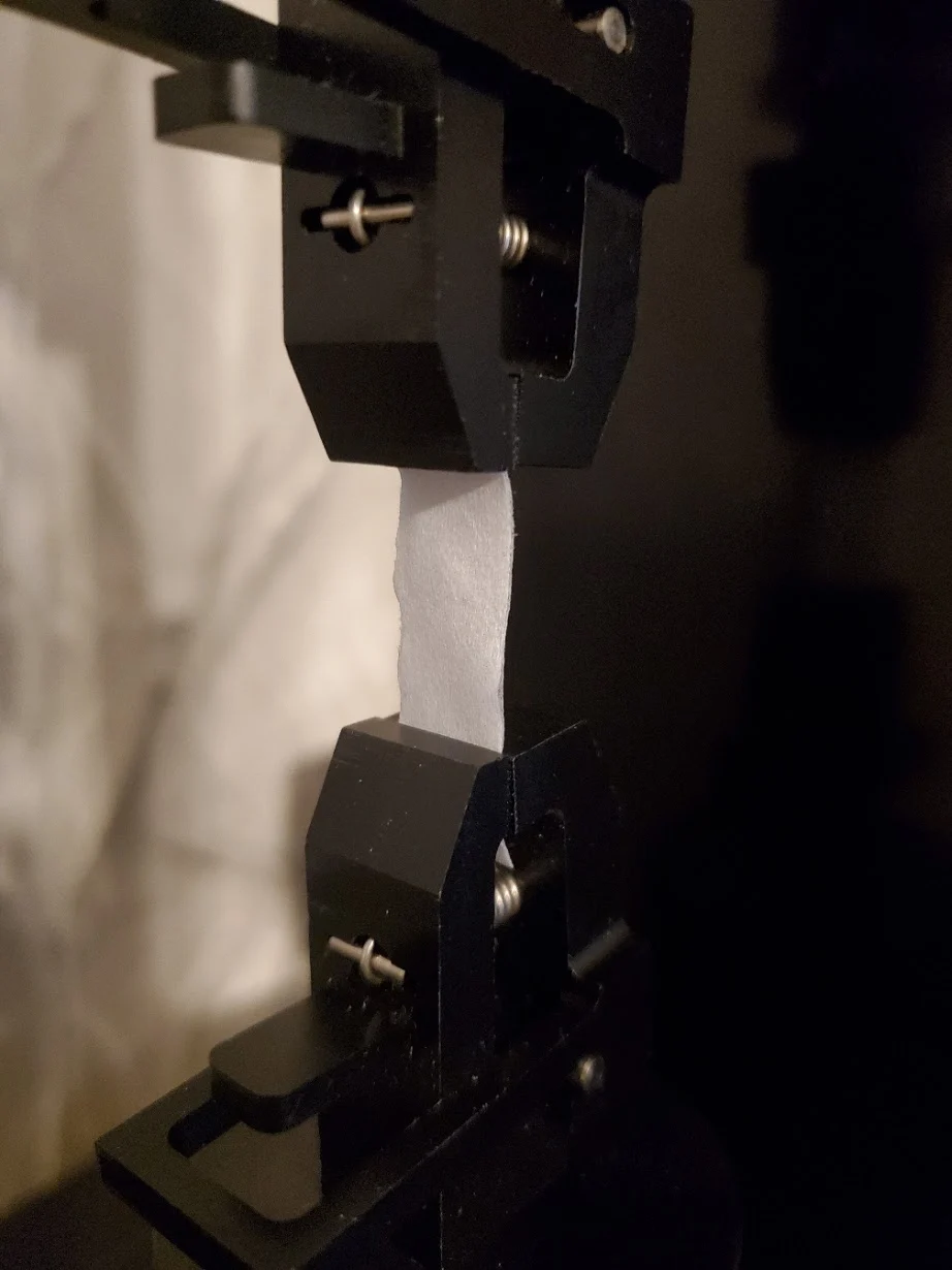 Single-ply toilet paper mounted in the UniVert for tensile testing toilet paper strength analysis