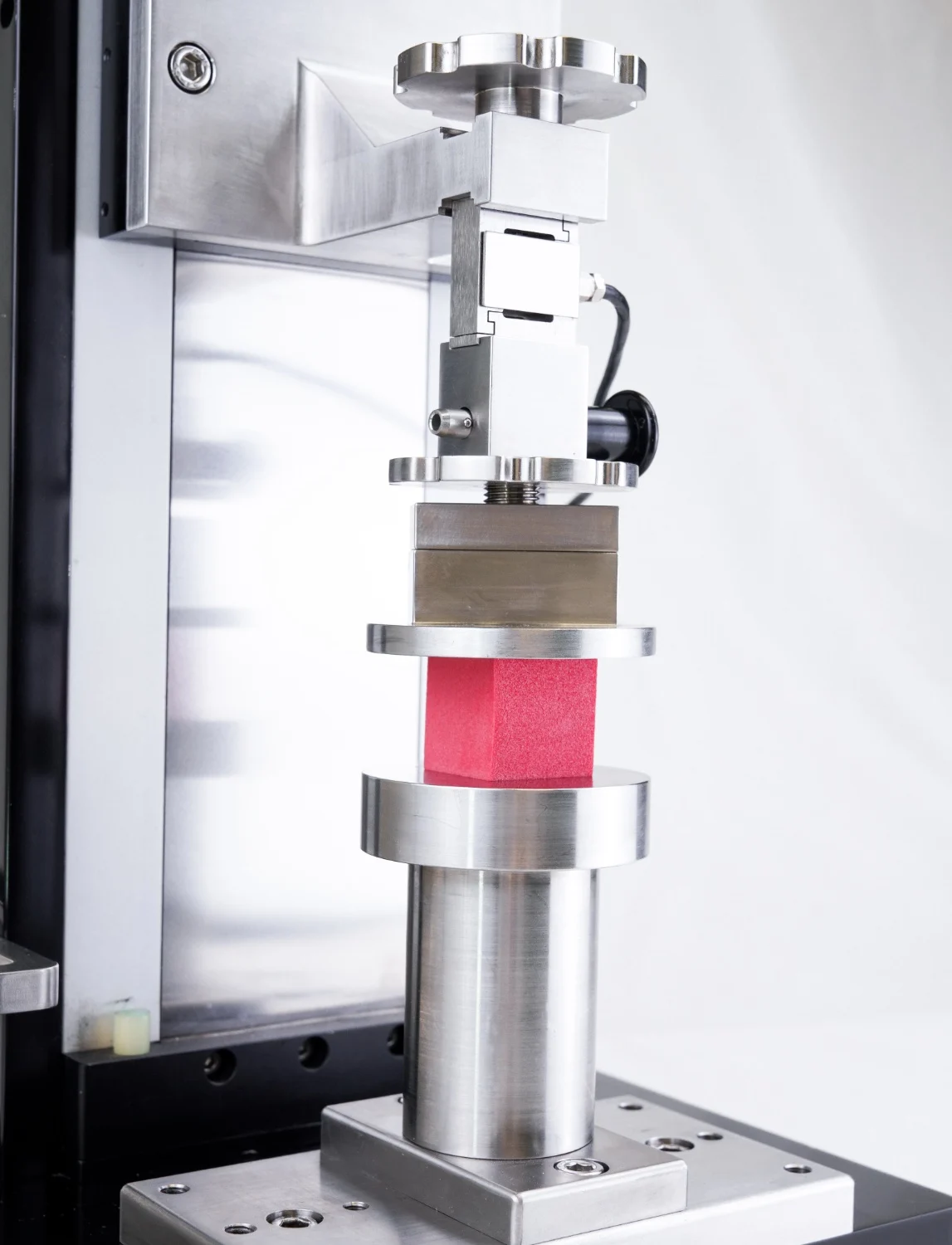 A closeup of a compression test on a square specimen on the UniVert 1kN