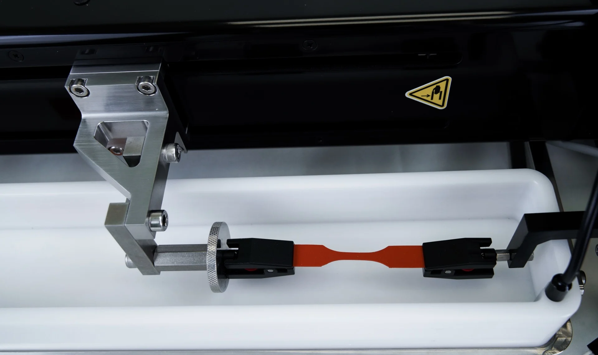 The UniVert tensile testing machine setup for tensile testing in a horizontal media bath