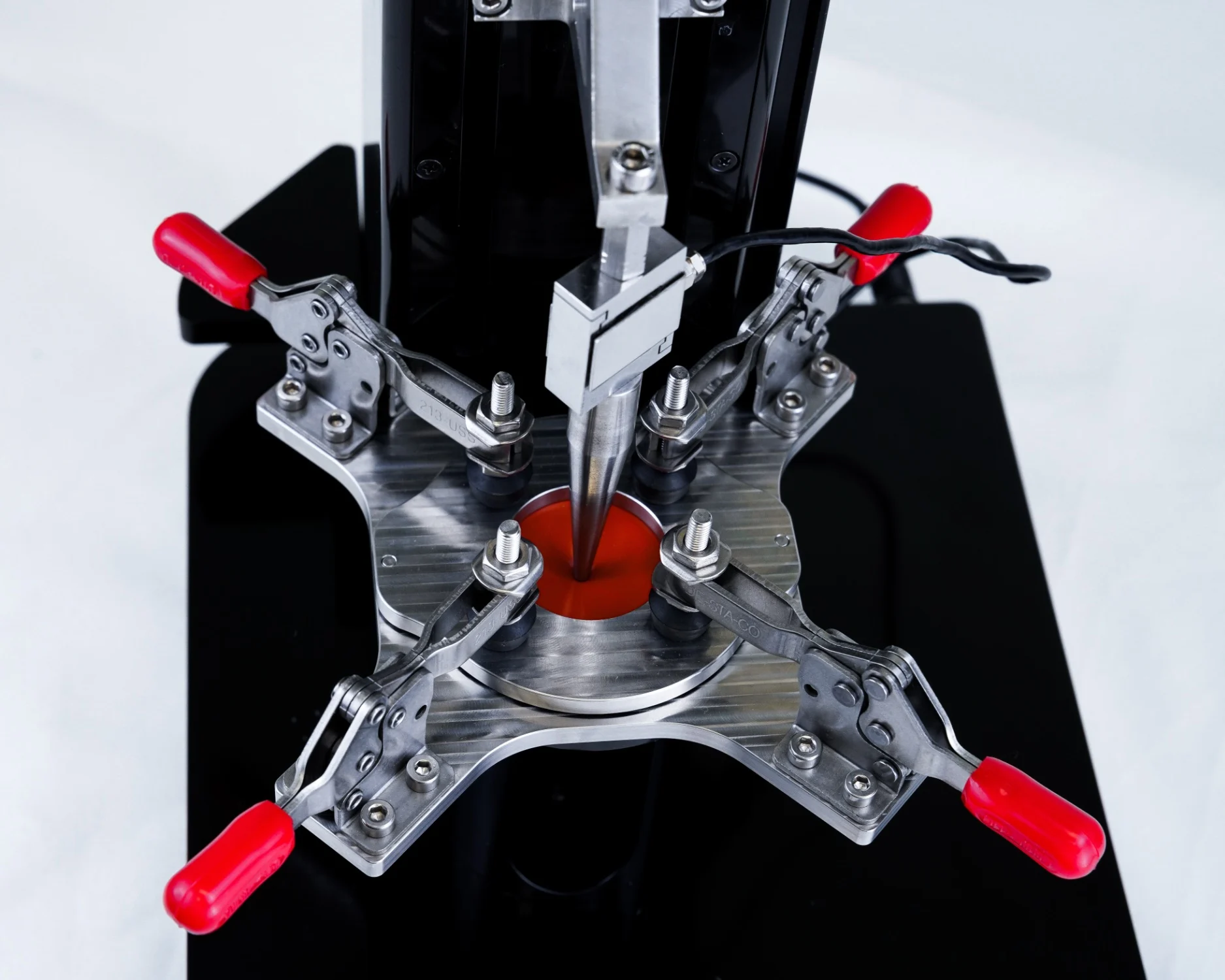 The puncture fixture with a sample specimen being mechanically tested on the UniVert