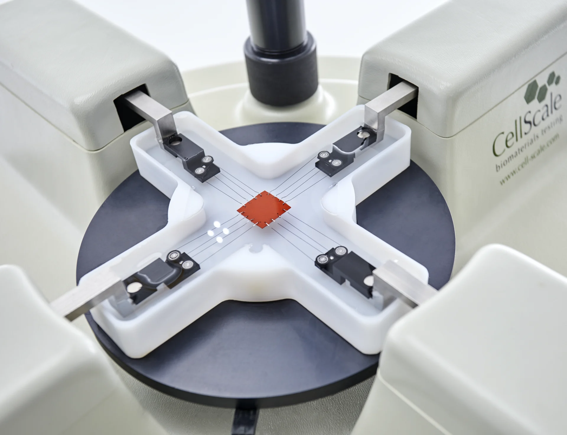 A sample mounted with pulleys in a media bath on a BioTester 5000 for biaxial testing