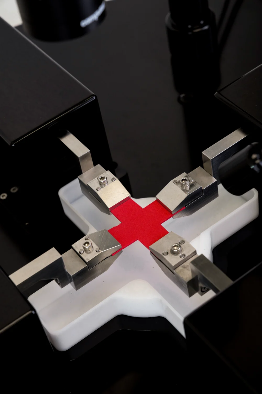 A sample being biaxially tested with clamps on the BioTester