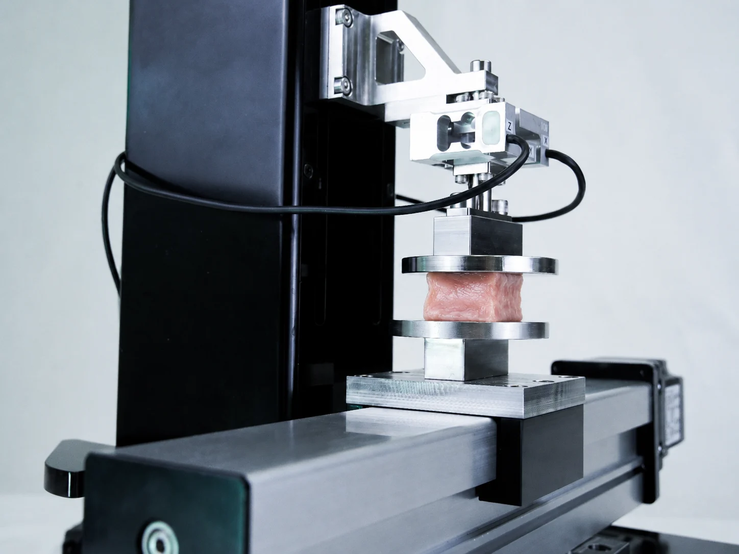 A pelvic floor sample being shear tested on the UniVert 1kN for pelvic floor biomechanics research