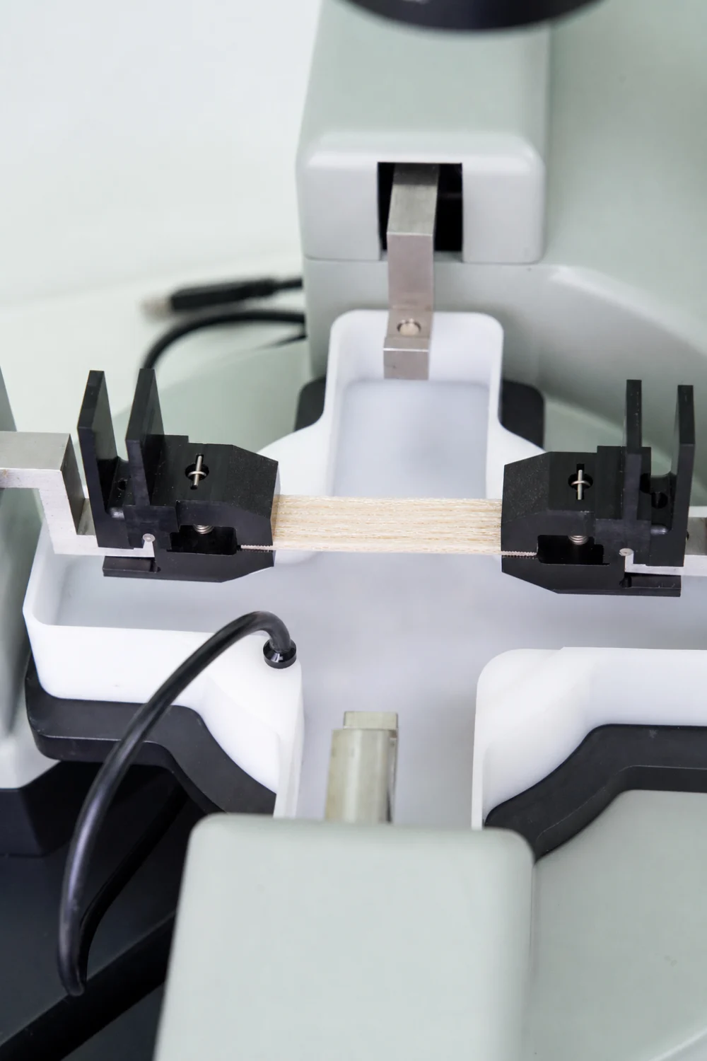A collagen fibre scaffold being tensile tested on the BioTester for scaffold mechanical testing research