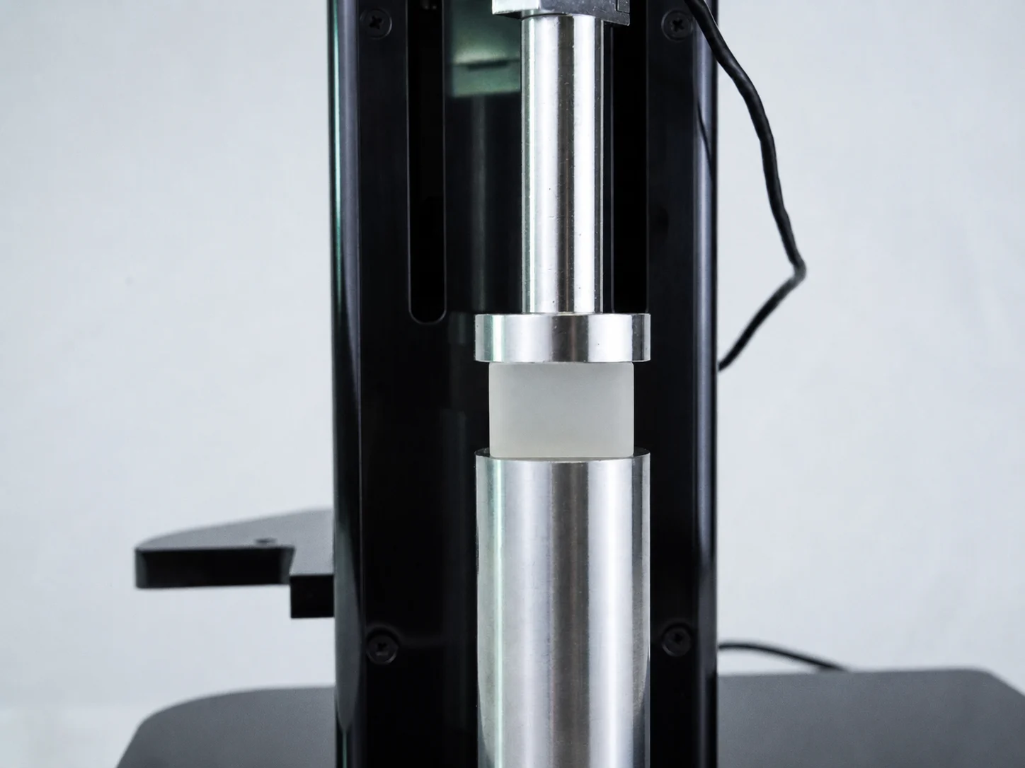 An elastomer block being compressed on a UniVert for elastomer mechanical testing research